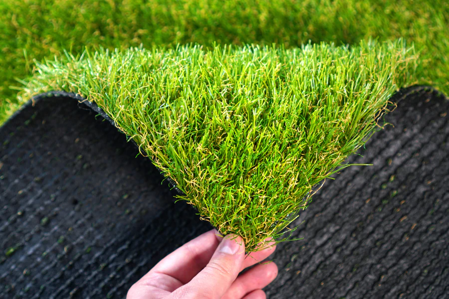 man inspecting synthetic grass